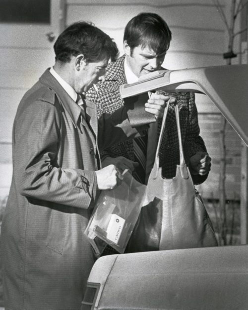 KEN GIGLIOTTI / WINNIPEG FREE PRESS  Detectives put personal effects of murder victim into the trunk of a car after a woman was found stabbed and beaten in the basement of a vacant Tyndall Park home November 16, 1979.  Winnipeg held a press conference June 14, 2016, asking the public for more information.