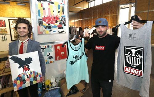 WAYNE GLOWACKI / WINNIPEG FREE PRESS     The Downtown Biz is launching their 4th Launch It! Retail Incubator program. At left, Josiah Koppanyi an artist with some of his work and Eric Olek with some of his Friday Knights brand shirts he is selling, they are two of the three entrepreneurs that have been selected for the space available in the Warehouse One space at Portage Ave and Carleton St.    Alex De Pape¤story    June 14  2016