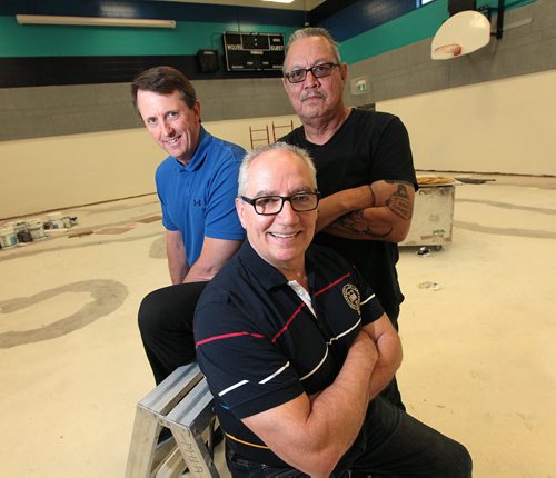 PHIL HOSSACK / WINNIPEG FREE PRESS -  Left to right, Mark Chipman, Tom Lussier (front) and Larry Morrissette pose inside the new gym being renovated as part of the new Gonzaga independent school in the north end. See Dan Lett's story re: a public art project being used to dispel fears of another residential school. June 14, 2016