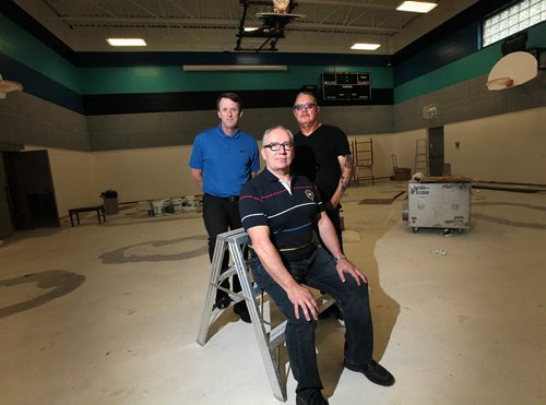 PHIL HOSSACK / WINNIPEG FREE PRESS -  Left to right, Mark Chipman, Tom Lussier (front) and Larry Morrissette pose inside the new gym being renovated as part of the new Gonzaga independent school in the north end. See Dan Lett's story re: a public art project being used to dispel fears of another residential school. June 14, 2016