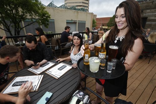 JOHN WOODS / WINNIPEG FREE PRESS Kelly Moslenko serves beverages on the roof top patio at La Roca photographed for an Intersection feature Tuesday, June 14, 2016.