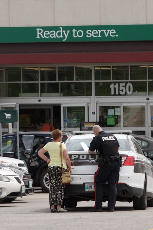 JOE BRYKSA / WINNIPEG FREE PRESS Police investigate possible firearm discharge in parking lot east of Sobeys on Taylor Tuesday, They interview shoppers who seen incident-June 15, 2016   -(See story)