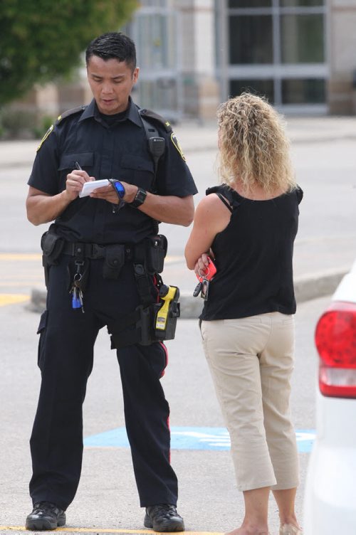 JOE BRYKSA / WINNIPEG FREE PRESS Police investigate possible firearm discharge in parking lot east of Sobeys on Taylor Tuesday, They interview shoppers who seen incident-June 15, 2016   -(See story)