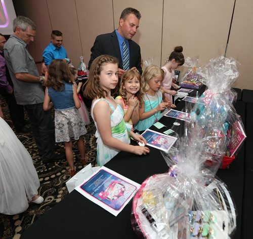 JASON HALSTEAD / WINNIPEG FREE PRESS  Attendees check out the silent auction table at the Childrens Hospital Foundation of Manitobas Father-Daughter Ball at the Victoria Inn Hotel and Convention Centre on June 9, 2016. (See Social Page)