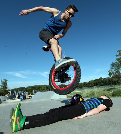 PHIL HOSSACK / WINNIPEG FREE PRESS -   Unicyclists Ruel Neuman Leaps over Louis Stevens for Dave Sanderson's story. June 15, 2016