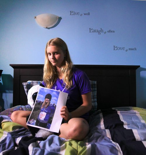 RUTH BONNEVILLE / WINNIPEG FREE PRESS  2017 Project: Grade 11, Glen Lawn student Naomi holds a picture of herself taking part in a Mental Health Run for women in her bedroom.  She talks openly about  her own challenges dealing with mental health issues and hopes her candour will bring more awareness and support to young people dealing with similar mental health issues. Naomi is one of a group of students from Windsor School that the Free Press has been following throughout his school years.       See Doug Speirs story.   June 15 / 2016