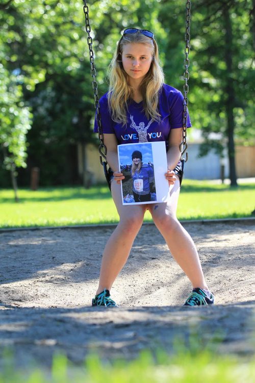 RUTH BONNEVILLE / WINNIPEG FREE PRESS  2017 Project: Grade 11, Glen Lawn student Naomi holds a picture of herself taking part in a Mental Health Run for women on a swing near her school.  She talks openly about  her own challenges dealing with mental health issues and hopes her candour will bring more awareness and support to young people dealing with similar mental health issues. Naomi is one of a group of students from Windsor School that the Free Press has been following throughout his school years.       See Doug Speirs story.   June 15 / 2016