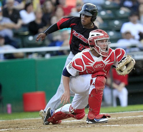 PHIL HOSSACK / WINNIPEG FREE PRESS -   Texas Air Hog ##23 Burt Reynolds scores the Hog's 5th run of the game, 4th of the top of the 5th inning behind Winnipeg Goldeye catcher Tanner Murphy making the catch off home plate. See story. June 15, 2016