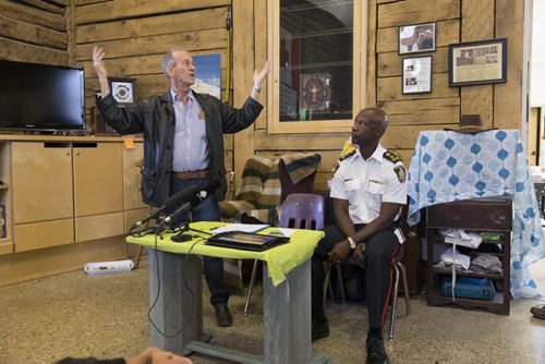 ZACHARY PRONG / WINNIPEG FREE PRESS  Sel Burrows, left, the chair of the North Point Douglas Residents Committee gives a speech at the Barber House in North Point Douglas during an event honouring outgoing Winnipeg Chief of Police Devon Clunis, right, on June 16, 2016.