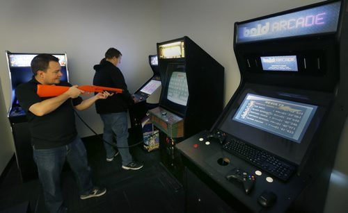 WAYNE GLOWACKI / WINNIPEG FREE PRESS    Bold employee, Chris Pappas trys his shooting skills on the arcade game Big Buck Hunter in the Bold Arcade during the Winnipeg Tech Company Bold 's open house  held Thursday. Bold went from 4 employees in January 2013 to 100 employees in highly skilled job roles as of June 2016. ¤The company is aiming to reach 230 employees in the next 24-36 months. Employee perks include arcade games and foosball in the office, daily catered lunches for staff, on-site workout facilities, stock options and flex hours. ¤ Martin Cash story    June 16  2016