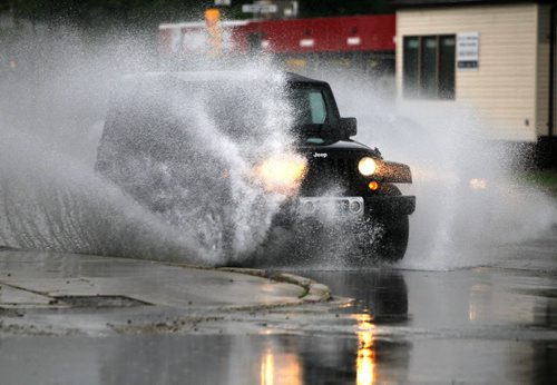 BORIS MINKEVICH / WINNIPEG FREE PRESS A jeep plows through the flooded St. Annes Road near Regal Ave. Early morning thunder storms dumped rain on the city. June 17, 2016.