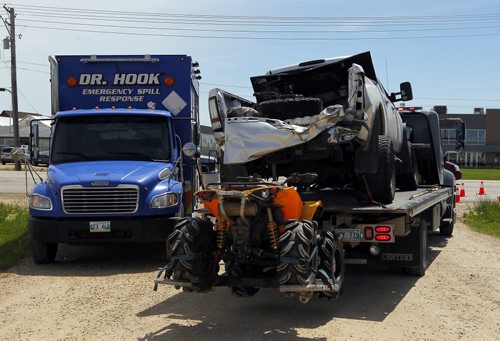 BORIS MINKEVICH / WINNIPEG FREE PRESS A truck and ORV loaded on a tow truck involved in MVC involving 3 vehicles. A horse trailer was involved too. Minor injuries. Horses were transferred to another horse trailer and taken away. This is all that was left on scene. Oil and fluids were cleaned up by special crew on scene. June 17, 2016.