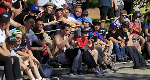 PHIL HOSSACK / WINNIPEG FREE PRESS - SK8 - Manitoba boarders crowd at the sidelines  Forks Skate Park Friday afternoon as part of the Primitive Canadian National Skate Tour  Make Canada Great Again. See release. STAND-UP  June 17, 2016