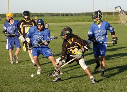 ZACHARY PRONG / WINNIPEG FREE PRESS  Number 18 Corey Boehm of the River East Kodiaks and number 28 Naral Narruda of the  Garden City Fighting Gophers race for the ball during the Division High School championship game on June 17, 2016.