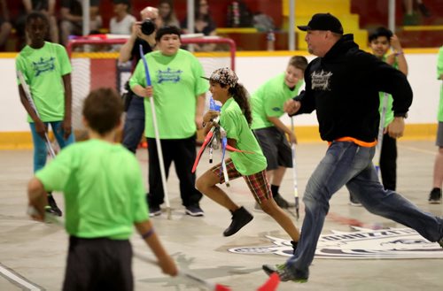 TREVOR HAGAN / WINNIPEG FREE PRESS Garth Brooks races a participant during his Teammates Ball Hockey ProCamp at Notre Dame Recreation Centre, Saturday, June 18, 2016.