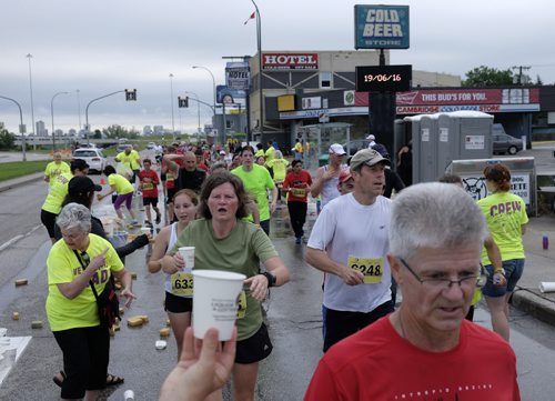 ZACHARY PRONG / WINNIPEG FREE PRESS  Volunteers hand out water and gatorade to participants in the Manitoba Marathon on June 19, 2016.