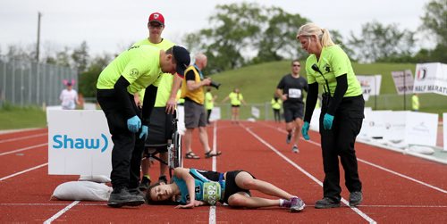 TREVOR HAGAN / WINNIPEG FREE PRESS Bib - Relay 5292 Runner #5 A 2016 Manitoba Marathon relay participant collapses just short of the finish line before eventually crawling across on her hands and knees, Sunday, June 19, 2016. She was runner #5 for relay team River Heights Fast & Furious Five.