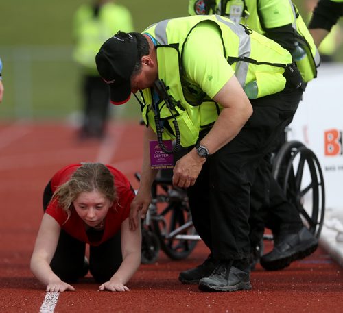 TREVOR HAGAN / WINNIPEG FREE PRESS Bib 6487- Jade - Half marathon A 2016 Manitoba Half Marathon participant Jade Blando of Winnipeg collapses just short of the finish line. She would try to crawl the rest of the way, but had to be helped into a wheelchair, Sunday, June 19, 2016.