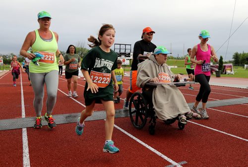 TREVOR HAGAN / WINNIPEG FREE PRESS 2016 Manitoba Marathon Super Run participants Lillia Perry (12521), Vanessa Croatto (12221), Debbie Chester (12295), Bianca Kicenko (12222), Stanley Wiebe (12995) at the finish line, Sunday, June 19, 2016.