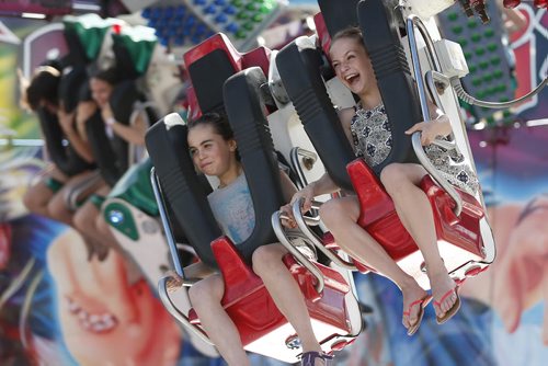 JOHN WOODS / WINNIPEG FREE PRESS Jordan Campbell (L) and her friend Ruby Friesen have fun on Re-Mix at the Red River Ex Sunday, June 19, 2016.