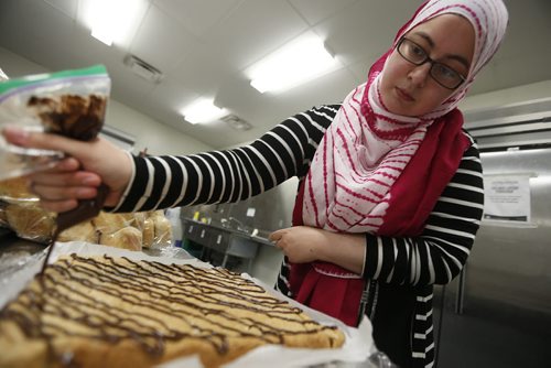 JOHN WOODS / WINNIPEG FREE PRESS Lubna Usmani, Manitoba Islamic Association Settlement Support Worker, prepares food for the Ramadan feast Sunday, June 19, 2016. Manitoba Muslims invited the public to the Grand Mosque Sunday after sundown  to break their Ramadan fast with them at a fund-raising dinner for the Coalition for Murdered and Missing Indigenous Women Sunday.
