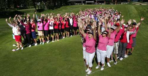 WAYNE GLOWACKI / WINNIPEG FREE PRESS   Participants in the 20th Annual Pink Ribbon Ladies Golf Classic For Hope pose in the shape of a giant pink ribbon for a group photo before teeing off at the Niakwa Country Club Monday morning. The fundraising event for CancerCare Manitoba Breast and Gyne Cancer Centre of Hope attracted 144 golfers, 36 male caddies and 60 volunteers this year.  Doug Speirs story  June 20  2016