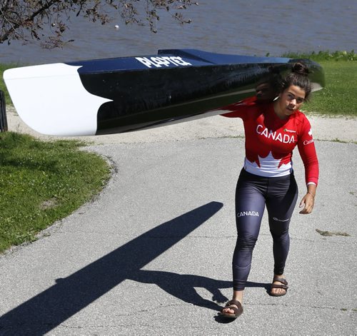 WAYNE GLOWACKI / WINNIPEG FREE PRESS   Nadya Crossman-Serb, a rising Winnipeg paddle carries a C1 canoe near the Red River by the Winnipeg Canoe and Kayak Centre. She recently won her first World Cup gold in women's C2.       Melissa Martin  story  June 20  2016