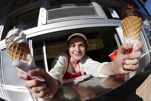 JOHN WOODS / WINNIPEG FREE PRESS Twist and vanilla with chocolate dip cones are served up by Micaela Stokes at the Bridge Drive-In Monday, June 20, 2016.