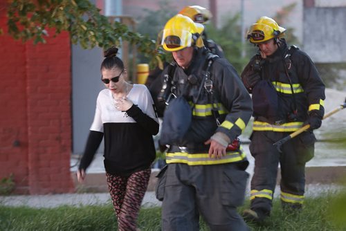 JOHN WOODS / WINNIPEG FREE PRESS Fire fighters remove a resident from a Jarvis Avenue apartment block. Emergency crews were called to a fire at 187 Jarvis Avenue Monday, June 20, 2016.