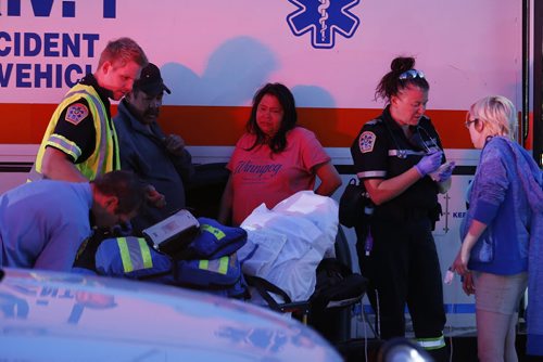JOHN WOODS / WINNIPEG FREE PRESS Paramedics attend to evacuated residents of a Jarvis Avenue apartment block. Emergency crews were called to a fire at 187 Jarvis Avenue Monday, June 20, 2016.