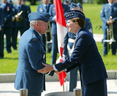 BORIS MINKEVICH / WINNIPEG FREE PRESS Canadian Airforce Major-General Christian Drouin, left, gets a welcoming handshake from 4 star US Air Force General Lori J. Robinson (commander-in-chief of NORAD), right. Major-General Christian Drouin assumed command of 1 Canadian Air Division (1 CAD) from Major-General David Wheeler in Winnipeg at 17 Wing. Lieutenant-General Michael Hood, Commander of the Royal Canadian Air Force presided over the ceremony. June 20, 2016.