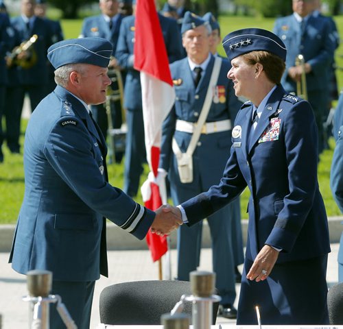 BORIS MINKEVICH / WINNIPEG FREE PRESS Canadian Airforce Major-General Christian Drouin, left, gets a welcoming handshake from 4 star US Air Force General Lori J. Robinson (commander-in-chief of NORAD), right. Major-General Christian Drouin assumed command of 1 Canadian Air Division (1 CAD) from Major-General David Wheeler in Winnipeg at 17 Wing. Lieutenant-General Michael Hood, Commander of the Royal Canadian Air Force presided over the ceremony. June 20, 2016.