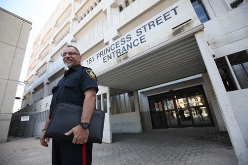 RUTH BONNEVILLE / WINNIPEG FREE PRESS  Constable Rob Carver stands outside the soon to be closed PSB after press conference outside  Tuesday.  The Public Information Office conducted a media briefing  announcing Closure of Public Safety Building.    June 21 / 2016