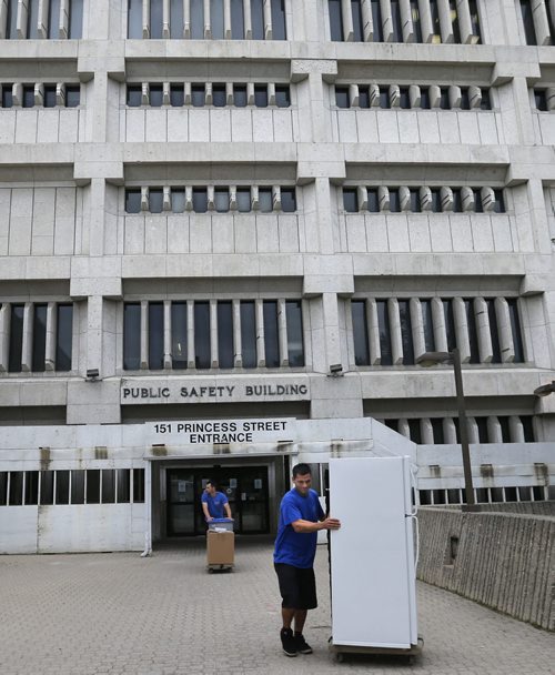 WAYNE GLOWACKI / WINNIPEG FREE PRESS   Movers empty the Public Safety Bld. on Princess St. that officially closed at 7am Wednesday. June 22  2016