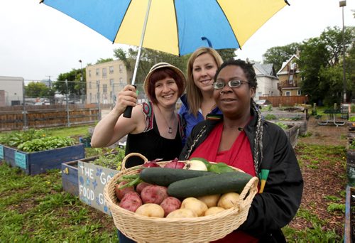 RUTH BONNEVILLE / WINNIPEG FREE PRESS  Coordinators with Good Food Club, Ailene Deller (right, blond) and Kelly Frazer, as well as member/participant who uses the program, Farrah Rose (front)  pose for a photo for story on food club which  allows members to buy cheap veggies using sweat equity. They help out at a farm, they harvest veggies, they buy them at reduced rate.   June 21 / 2016