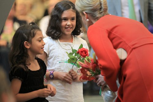 RUTH BONNEVILLE / WINNIPEG FREE PRESS  Countess of Wessex chats with Samantha Schlosser and her little sister Isabella from Brandon after they gave her flowers from their family garden while she tours  of Deer Lodge for its 100th birthday Wednesday.   June 22 / 2016