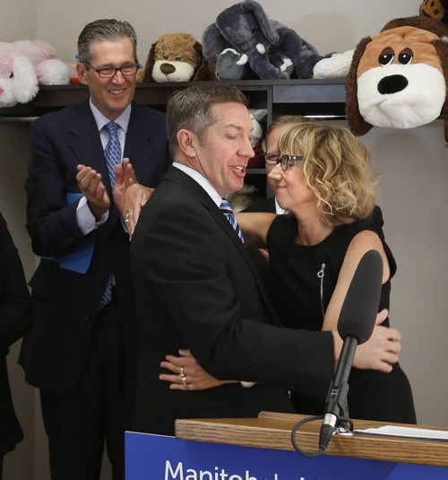 WAYNE GLOWACKI / WINNIPEG FREE PRESS   Cheryl Martinez,Executive Director of  Snowflake Place for Children and Youth embraces Sheldon Kennedy of  Sheldon Kennedy Child Advocacy Centre and co-founder the Respect Group at a news conference held by Premier Brian Pallister at left. The provincial gov't gave details of new legislation to better protect children in Manitoba at at news conference held Thursday at the Snowflake Place for Children and Youth. Larry Kusch story June 23  2016