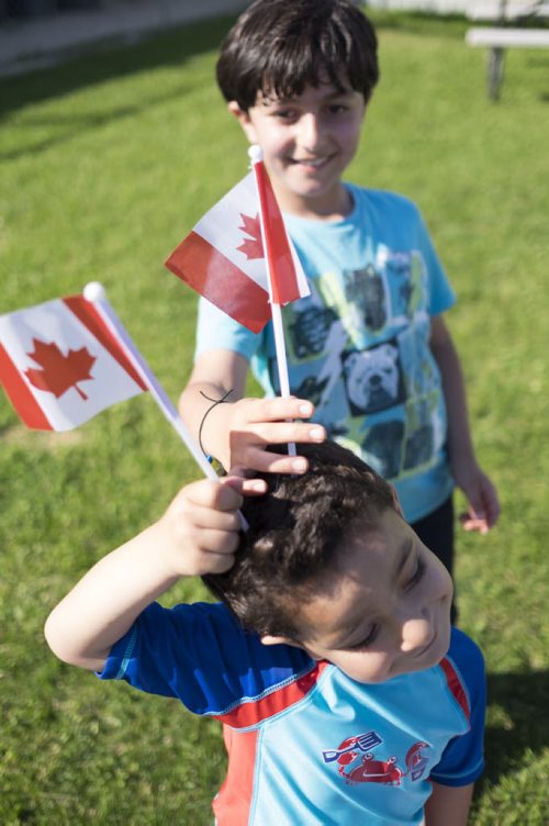 ZACHARY PRONG / WINNIPEG FREE PRESS  ( F-B)Hussein Alassaf, 5, and Rodi Salesman, 8, play outside of a local community centre where their parents study English each week. June 15, 2016.