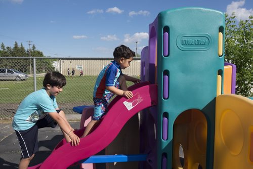 ZACHARY PRONG / WINNIPEG FREE PRESS  (L-R) Rodi Salesman, 8, and Hussein Alassaf, 5, play outside of a local community centre where their parents study English each week. June 15, 2016.