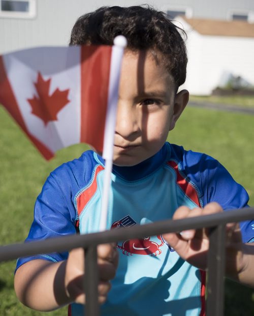 ZACHARY PRONG / WINNIPEG FREE PRESS  Hussein Alassaf, 5, plays outside of a local community centre where his parents study English each week. June 15, 2016.