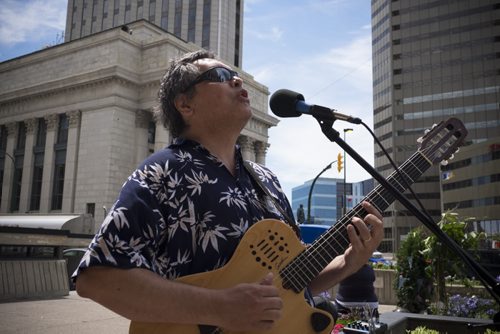 ZACHARY PRONG / WINNIPEG FREE PRESS  Marco Castillo, a Winnipeg based musician originally from Brazil, performs during the Cultural Corner, part of the Imagine Portage and Main Pop-up Series that will take place throughout the summer. Castillo and other artists from Folklorama Talent were playing on each corner of the downtown intersection on June 24, 2016. Organized by the City of Winnipeg, the Downtown Winnipeg BIZ, and the Exchange District BIZ, the Pop-up events will happen once each month and will include a farmers market, beer festival and dance party.