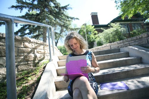 RUTH BONNEVILLE / WINNIPEG FREE PRESS  Maria Mitousis, a victim of a bomb blowing up in a package she opened a year ago, reads letters written by middle school students at Beaverlodge School in a park in the Wolsely area Friday  She pauses while responding to questions about what her life is like a year later.   Gordon Sinclair story.   June 23 / 2016