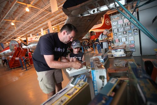 RUTH BONNEVILLE / WINNIPEG FREE PRESS    Six-year-old Griffin Baldwin and his dad Ryan rummage through old aircraft parts and models at The Royal Aviation Museum of Western Canada Saturday during their first-ever "Fly Market" Saturday morning.   See Alex Paul's story.   June 25 / 2016