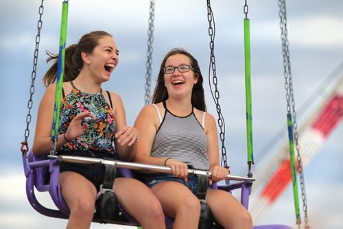 RUTH BONNEVILLE / WINNIPEG FREE PRESS  Kassidy Esau (left) and her friend Deanna Peters are excited to ride on the Swing Tower ride at the Red River Ex Saturday. Standup photo  June 25 / 2016