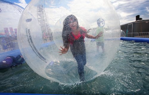 RUTH BONNEVILLE / WINNIPEG FREE PRESS  Ten-year-old Honey Frampton tries to walk on the water in the Wobbly Water Ball at the Red River Ex Saturday. Standup photo  June 25 / 2016