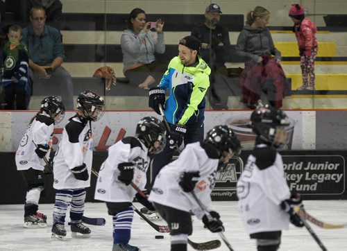 MIKE DEAL / WINNIPEG FREE PRESS  Winnipeg Jets Josh Morrissey helps out on the ice during the 2nd Annual Mark Scheifele Hockey Camp in support of KidSport Winnipeg at the Iceplex Sunday morning.   160626 Sunday, June 26, 2016