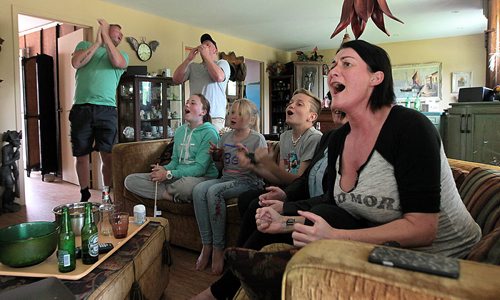 PHIL HOSSACK / WINNIPEG FREE PRESS -  Gerdur Gylfadottir (right) and her husband Kristinn Traustason (left) flank family on a couch cheering Iceland's Soccer team to a win over England. The Family is a recent arrivial to Canada. See Randy Turner's story.  - See story. June 27, 2016