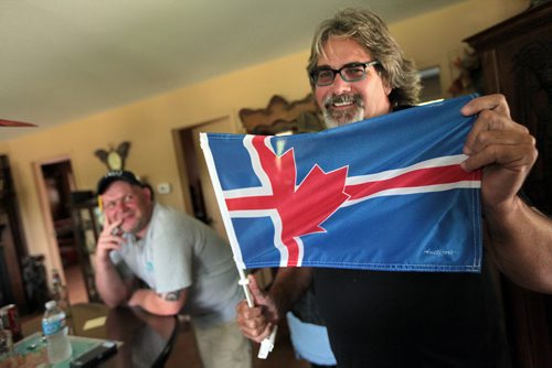 PHIL HOSSACK / WINNIPEG FREE PRESS -  Glen Martin shows off a hybrid Canadian/Icelandic flag at his home while watching the Iceland - England soccer match. See Randy Turner's story.  - See story. June 27, 2016