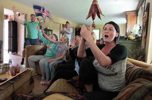 PHIL HOSSACK / WINNIPEG FREE PRESS -  Gerdur Gylfadottir (right) and her husband Kristinn Traustason (left) flank family on a couch cheering Iceland's Soccer team to a win over England. The Family is a recent arrivial to Canada. See Randy Turner's story.  - See story. June 27, 2016