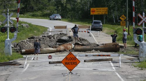 WAYNE GLOWACKI / WINNIPEG FREE PRESS  The  Highway 307 near Highway 44 where a track hoe was used Sunday to remove the culvert and a section of the road to release water buildup.  Bill Redekop Story June 27  2016